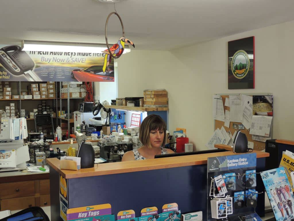 Samantha helping a customer at the Middlebury Lock front counter